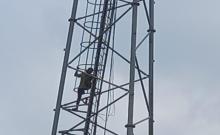 A husband climbs a tower for his wife